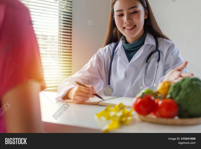 Nutritionist doctor apple showing asian heart hand woman red